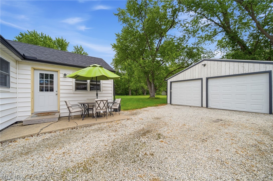 3471 State Rte 5 Newton Falls, OH 44444 - Photo 21 of 31 Gravel driveway and detached two-car garage with white paneled doors