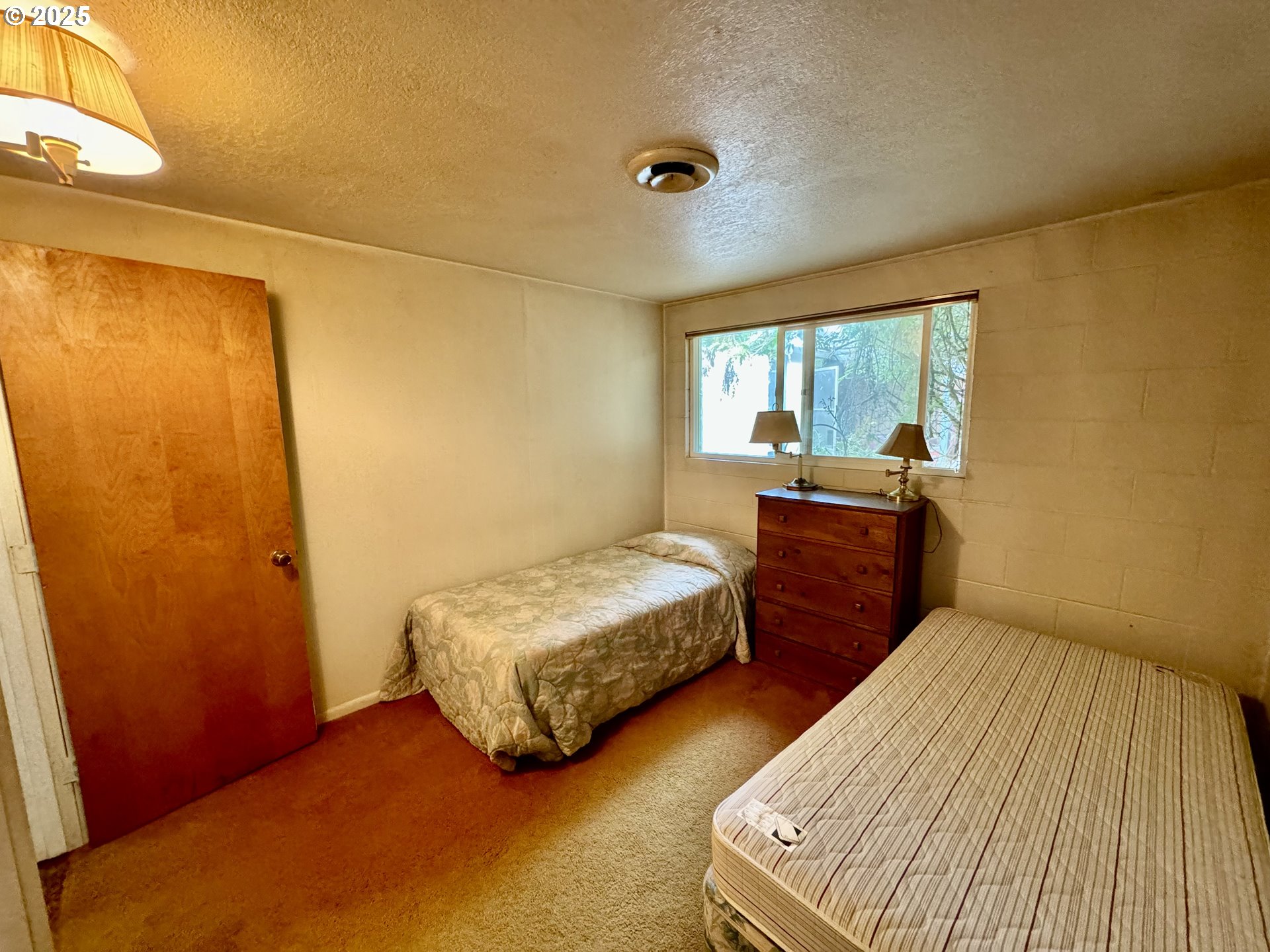 4990 Mitchell Loop Road Florence, OR 97439 - Photo 25 of 37 a bedroom with two beds and a window