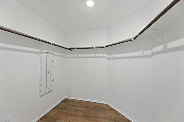 an empty room with wooden floor and window