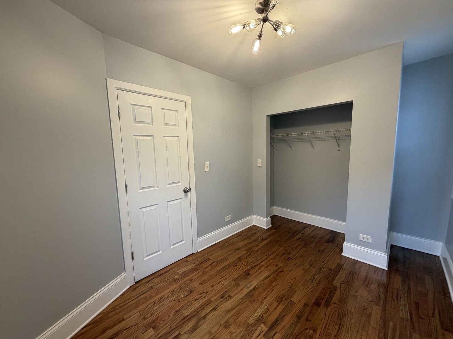 3614 West George Street, Unit 2R Chicago, IL 60618 - Photo 9 of 12 wooden floor in an empty room with a window
