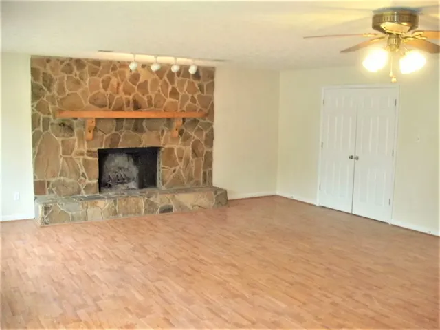 a view of empty room with a fireplace