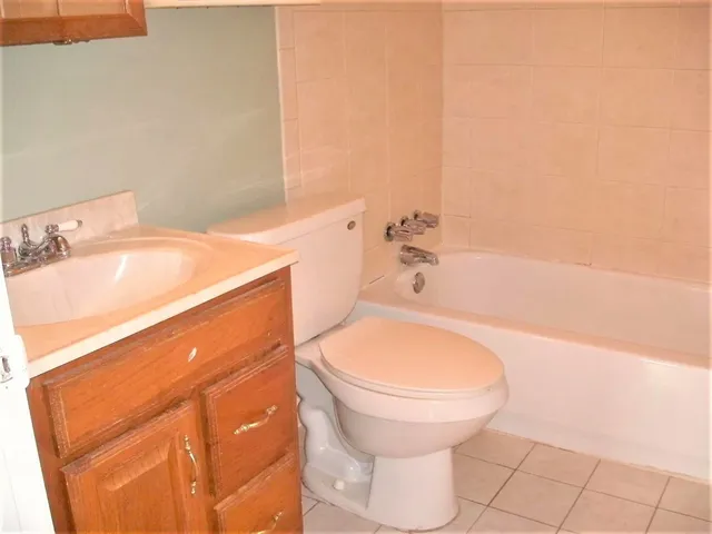 a bathroom with a sink a toilet and bathtub