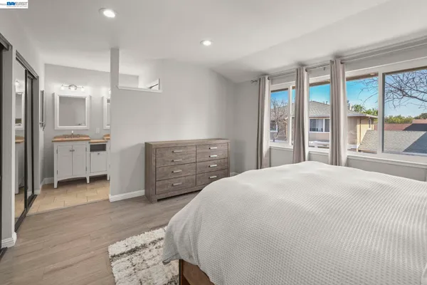 a spacious bedroom with a large bed and a dresser