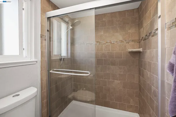 a bathroom with a shower and a toilet