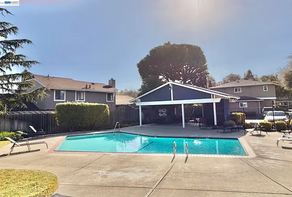 a front view of a house with a yard and table and chairs