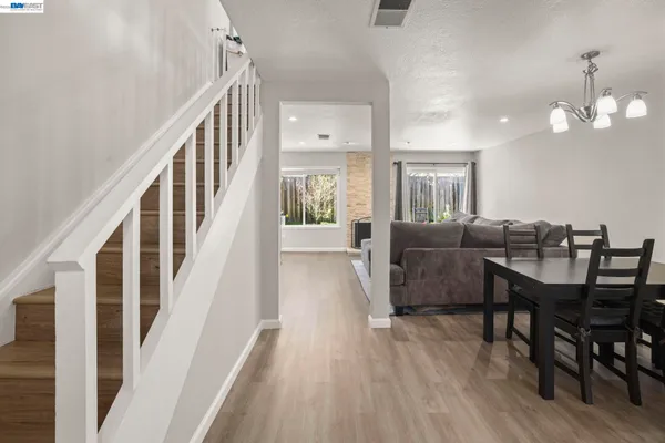 a view of a livingroom with furniture wooden floor and windows