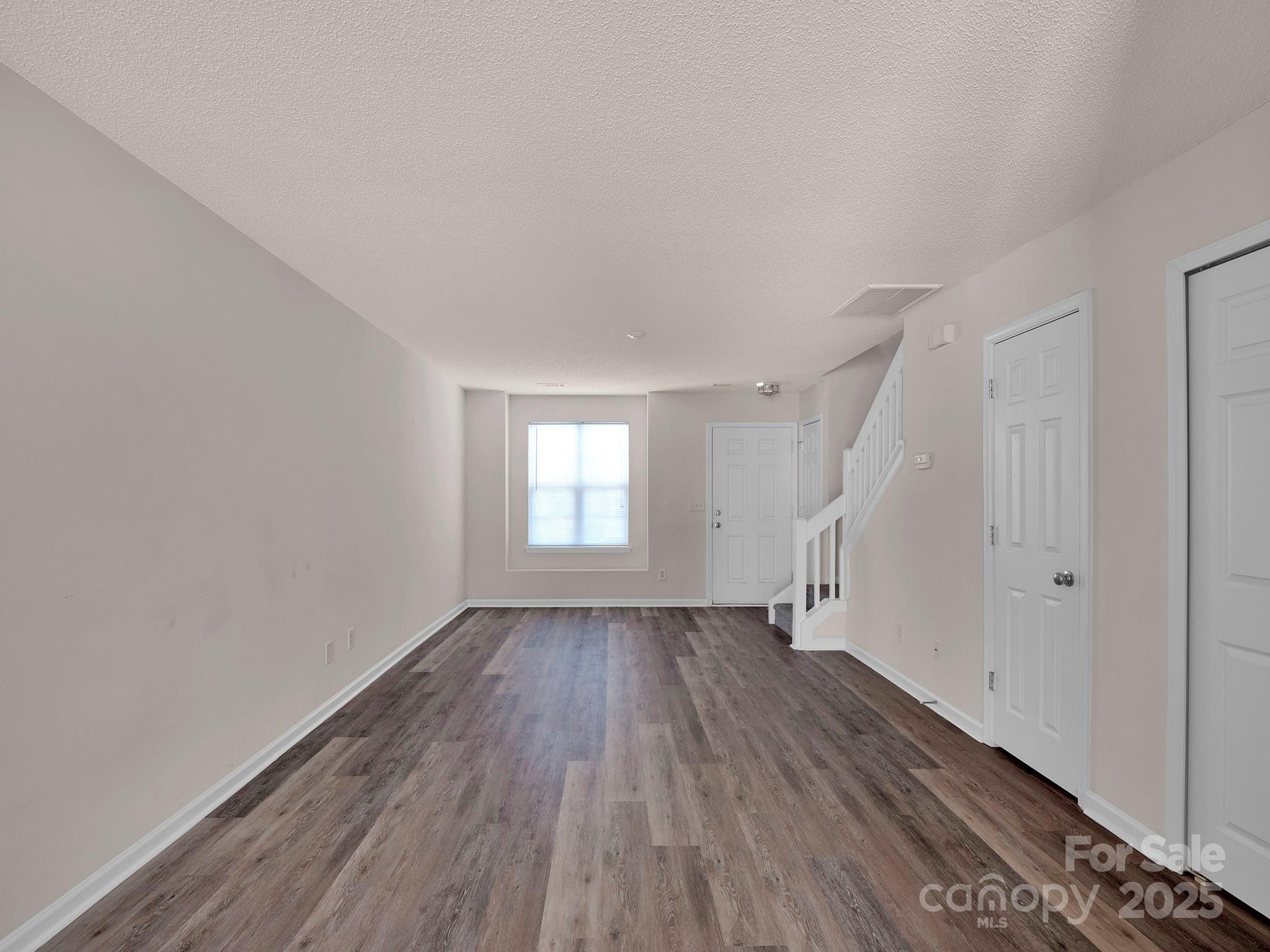 3209 Blythe Ridge Court Charlotte, NC 28213 - Photo 12 of 31 an empty room with wooden floor and windows