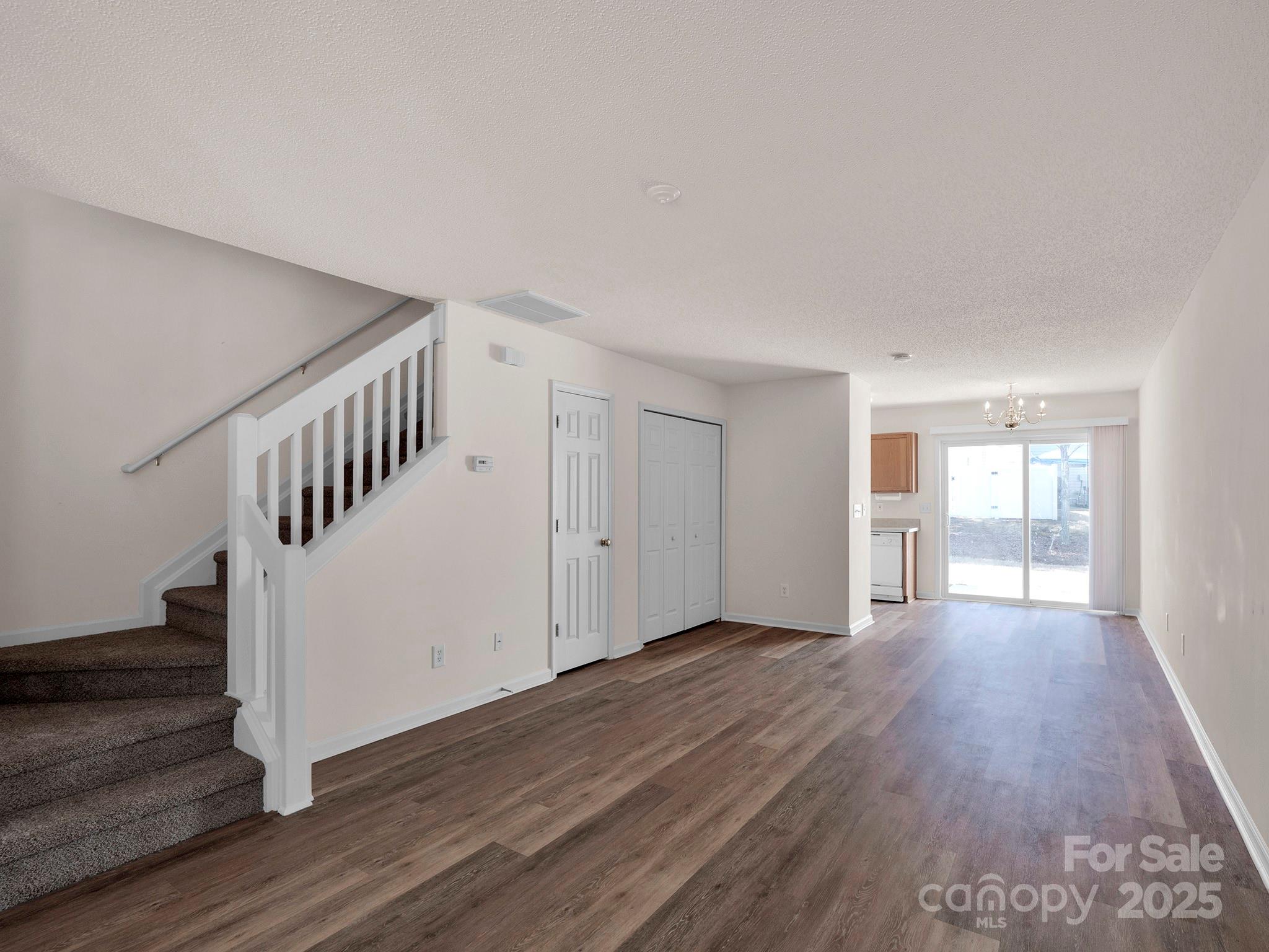 3209 Blythe Ridge Court Charlotte, NC 28213 - Photo 3 of 31 a view of an empty room with wooden floor and stairs