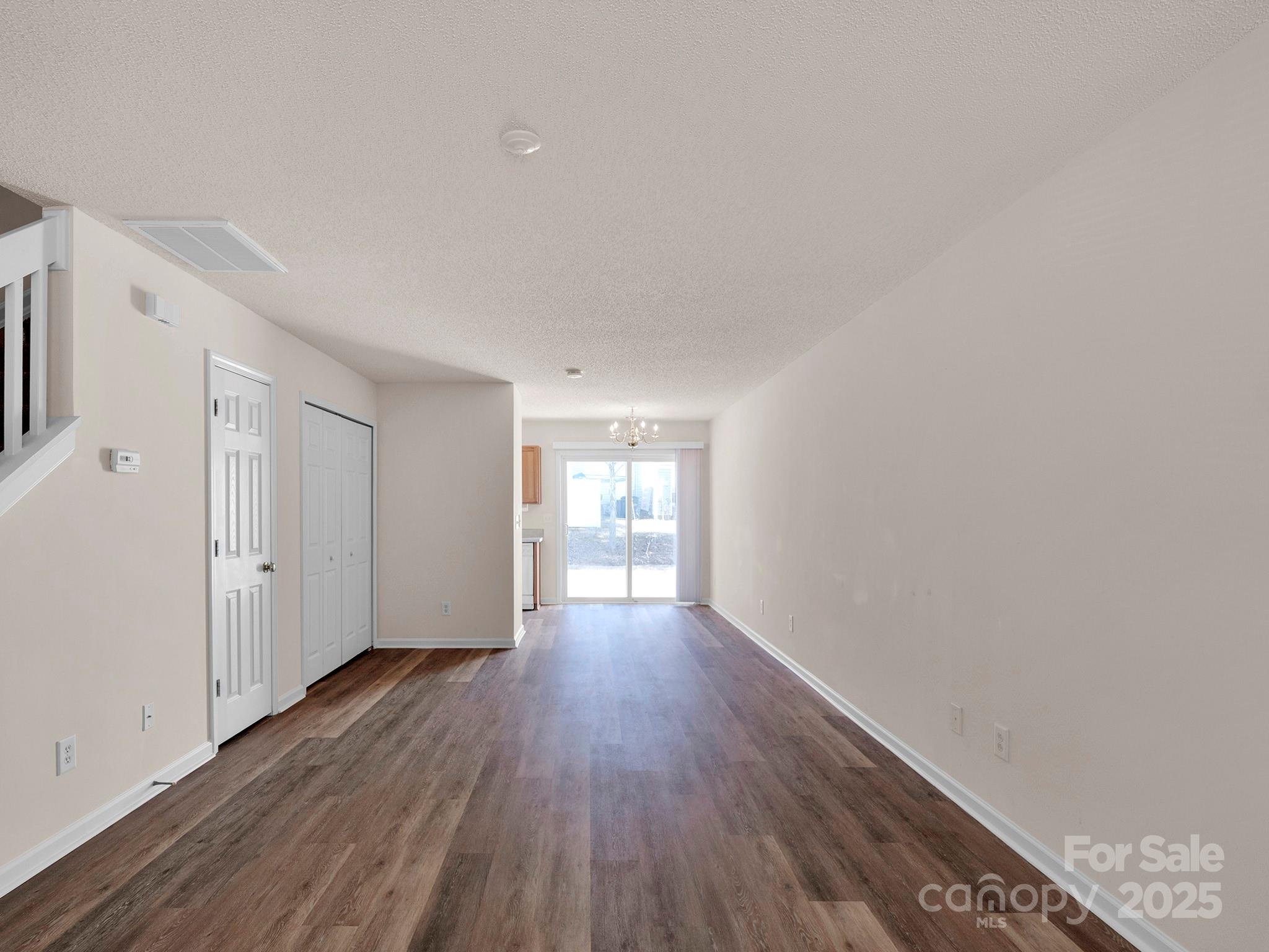 3209 Blythe Ridge Court Charlotte, NC 28213 - Photo 4 of 31 a view of an empty room with wooden floor and a window