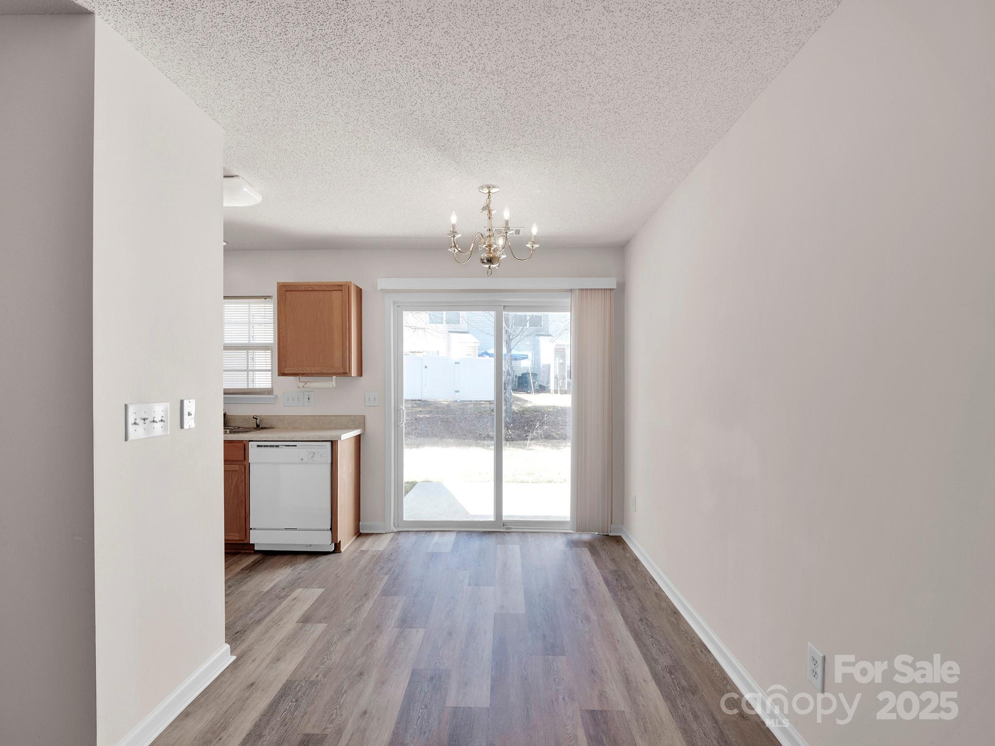 3209 Blythe Ridge Court Charlotte, NC 28213 - Photo 6 of 31 wooden floor in an empty room with a window