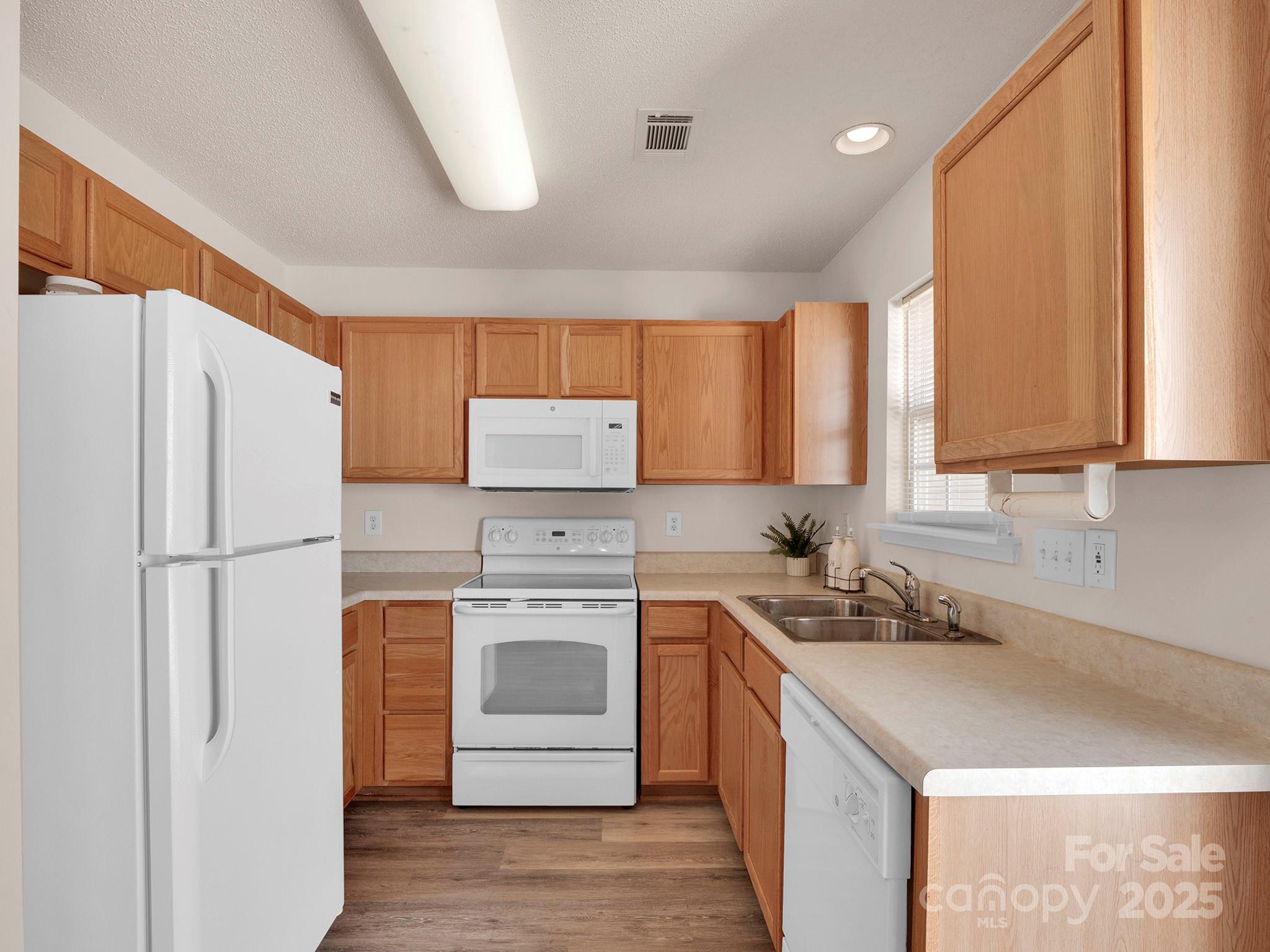 3209 Blythe Ridge Court Charlotte, NC 28213 - Photo 10 of 31 a kitchen with a refrigerator sink stove and cabinets