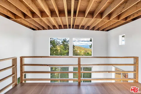 a view of wooden floor with windows