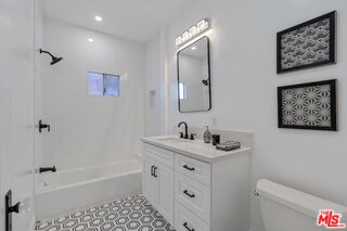 3034 Glen Avenue Altadena, CA 91001 - Photo 14 of 25 a bathroom with a granite countertop sink a toilet and a bathtub