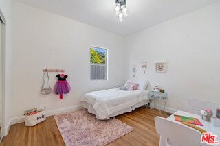 3034 Glen Avenue Altadena, CA 91001 - Photo 15 of 25 a bedroom with a bed and a chandelier