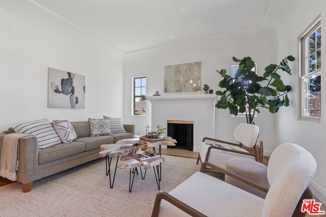 3034 Glen Avenue Altadena, CA 91001 - Photo 3 of 25 a living room with furniture a potted plant and a fireplace