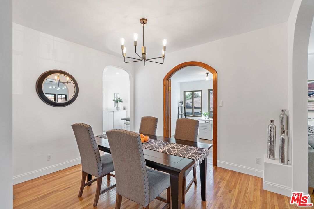 3034 Glen Avenue Altadena, CA 91001 - Photo 7 of 25 a view of a dining room with furniture a chandelier and wooden floor