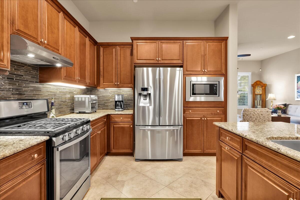 39048 Camino Orquesta Indio, CA 92203 - Photo 13 of 62 a kitchen with stainless steel appliances granite countertop a refrigerator stove and sink