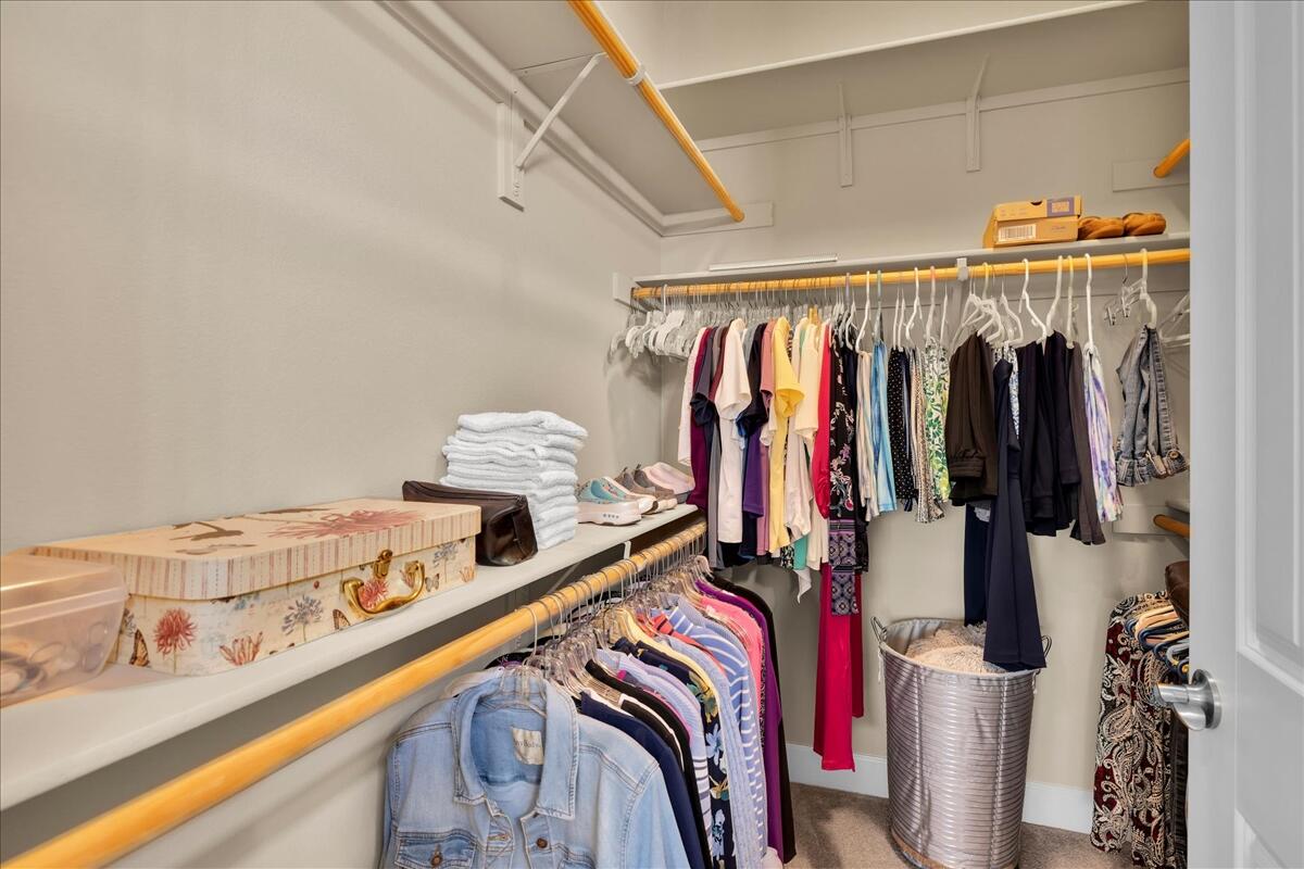 39048 Camino Orquesta Indio, CA 92203 - Photo 34 of 62 a view of walk in closet with clothes and shoes