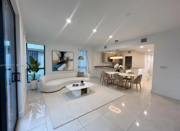 a living room with furniture and a potted plant