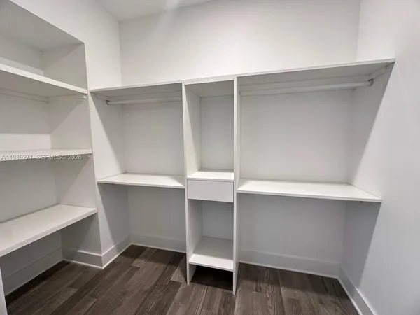 a view of walk in closet with empty racks