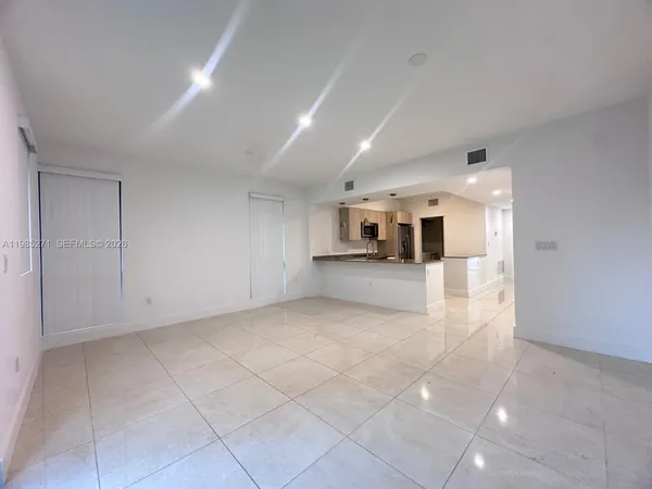 a view of a hallway with a kitchen