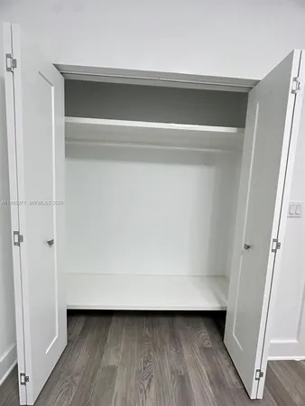 a view of a room with wooden floor