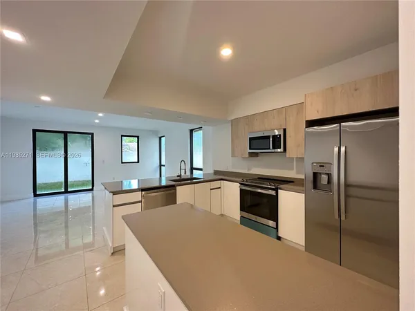 a large kitchen with cabinets and stainless steel appliances