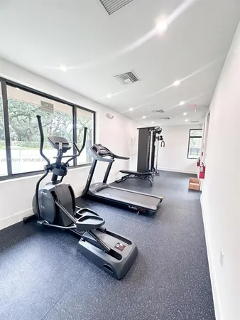 a room with gym equipment and a large window