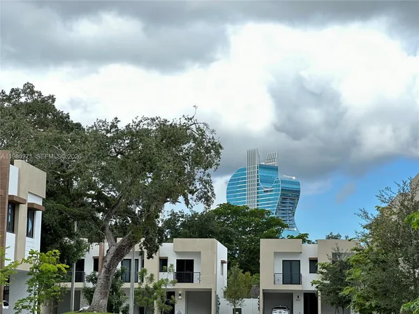 a view of a white house next to a building
