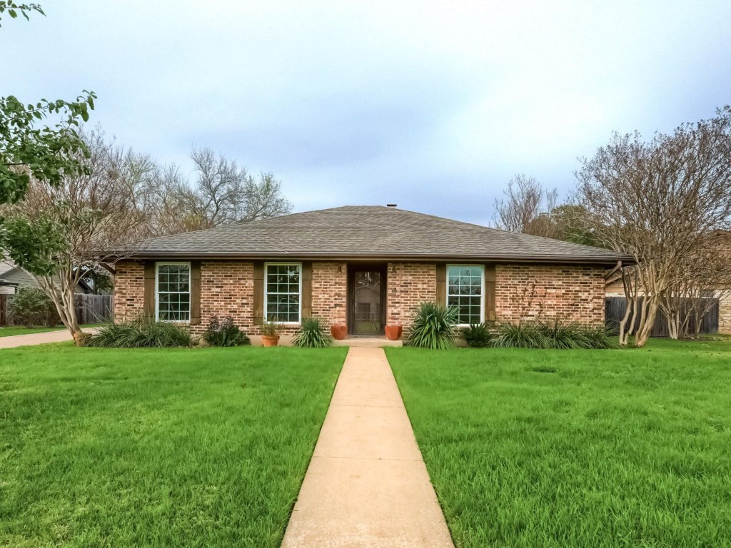 7202 Squirrel Oak Circle Austin, TX 78749 - Photo 1 of 1 a front view of a house with a garden