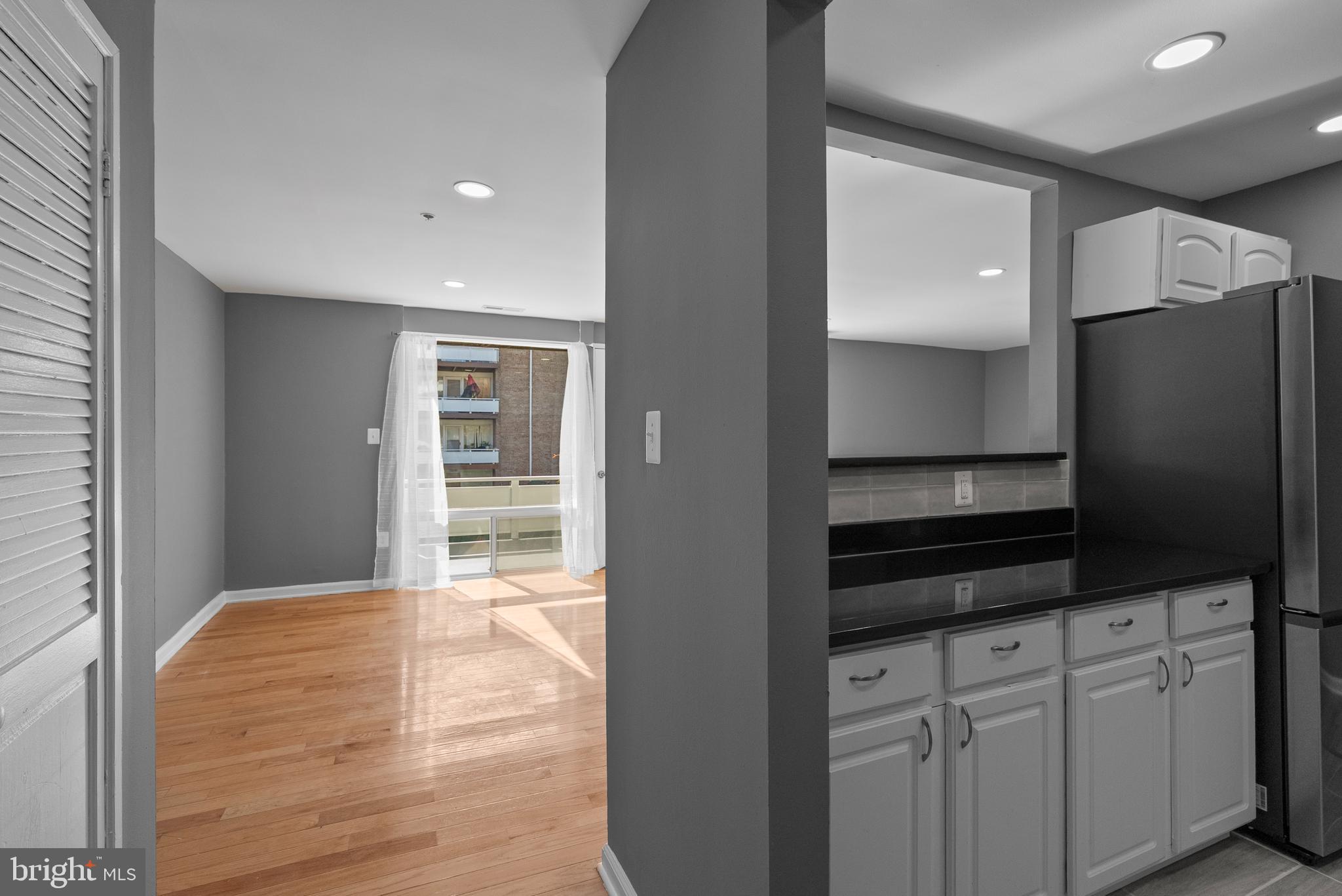 542 Wilson Bridge Drive, Unit 6743 B2 Oxon Hill, MD 20745 - Photo 4 of 27 a view of a kitchen with refrigerator and wooden floor