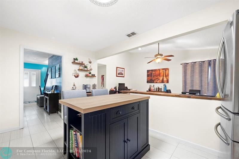 1088 Raintree Drive Palm Beach Gardens, FL 33410 - Photo 11 of 36 a large kitchen with a table and chairs