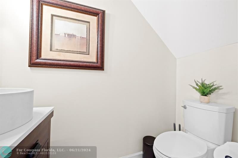 1088 Raintree Drive Palm Beach Gardens, FL 33410 - Photo 15 of 36 a white toilet sitting next to a bathroom sink