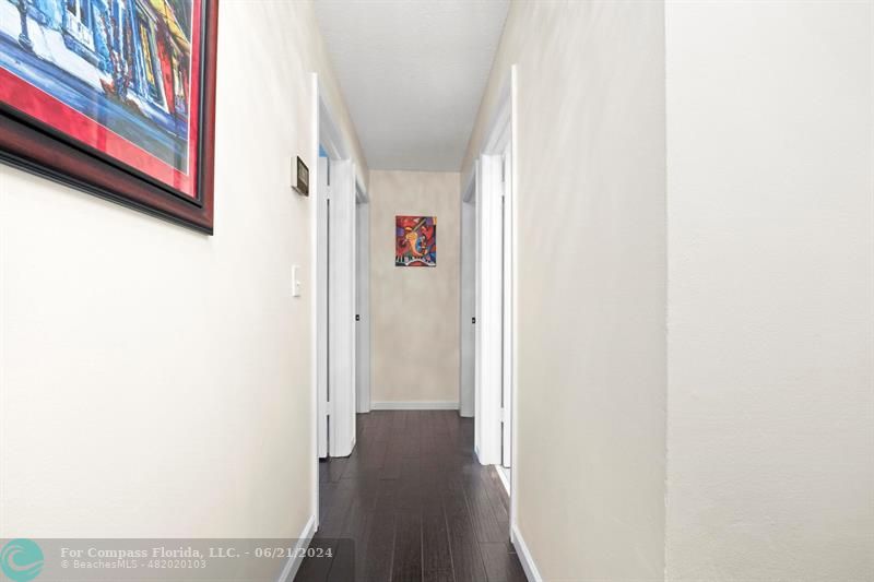 1088 Raintree Drive Palm Beach Gardens, FL 33410 - Photo 18 of 36 a view of a hallway with wooden floor