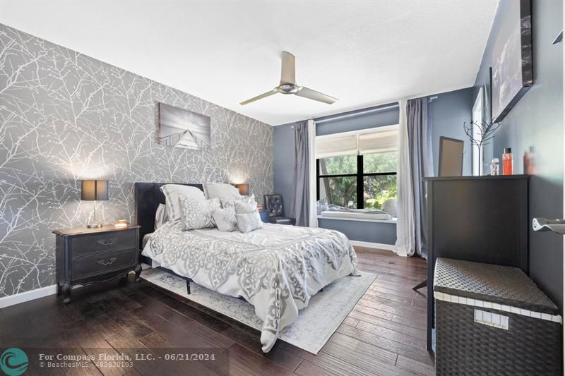 1088 Raintree Drive Palm Beach Gardens, FL 33410 - Photo 23 of 36 a bedroom with a large bed and a chandelier