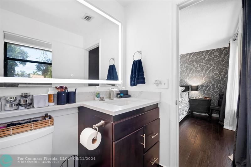 1088 Raintree Drive Palm Beach Gardens, FL 33410 - Photo 26 of 36 a bathroom with a sink double vanity and a mirror