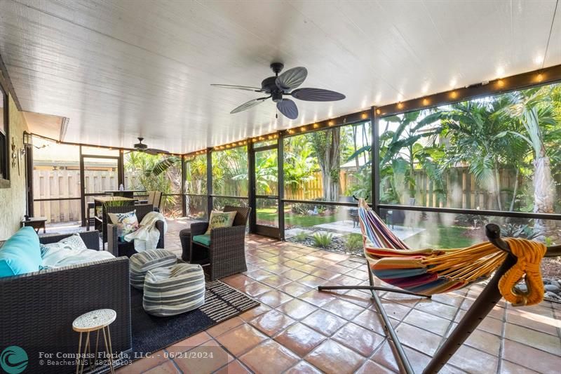 1088 Raintree Drive Palm Beach Gardens, FL 33410 - Photo 29 of 36 a living room with furniture and a floor to ceiling window
