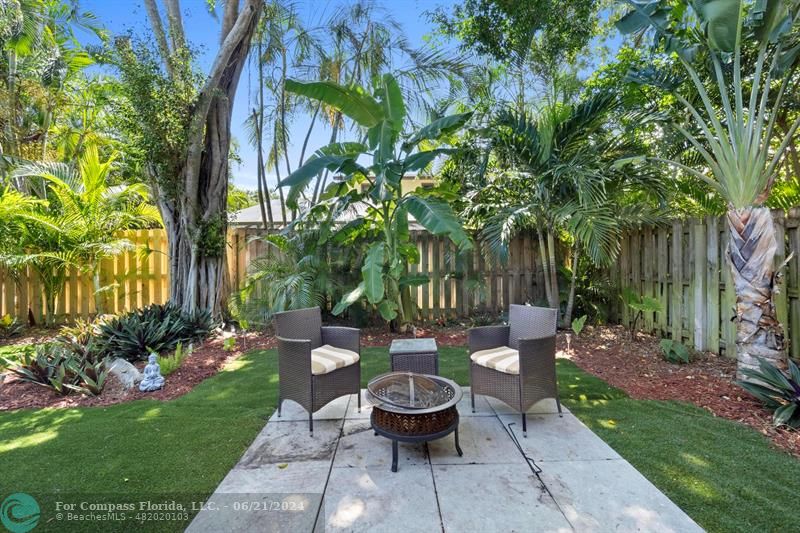 1088 Raintree Drive Palm Beach Gardens, FL 33410 - Photo 31 of 36 a view of a backyard with plants and garden