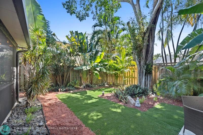 1088 Raintree Drive Palm Beach Gardens, FL 33410 - Photo 32 of 36 a view of a backyard with plants