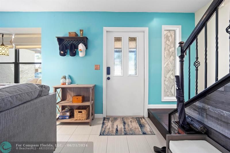 1088 Raintree Drive Palm Beach Gardens, FL 33410 - Photo 4 of 36 a living room with furniture and a window