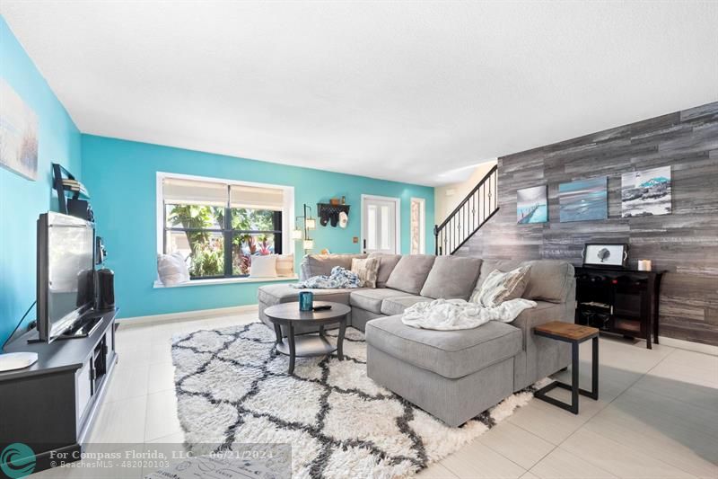 1088 Raintree Drive Palm Beach Gardens, FL 33410 - Photo 5 of 36 a living room with furniture a flat screen tv and a window
