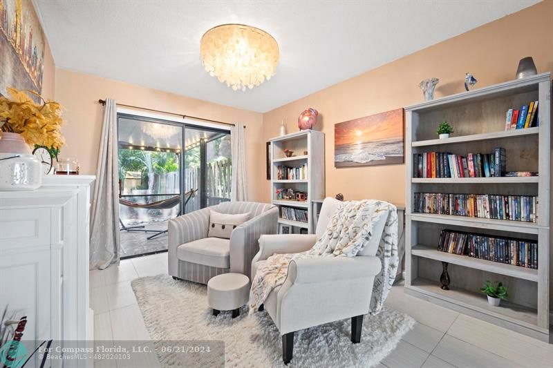 1088 Raintree Drive Palm Beach Gardens, FL 33410 - Photo 7 of 36 a living room with furniture and a book shelf
