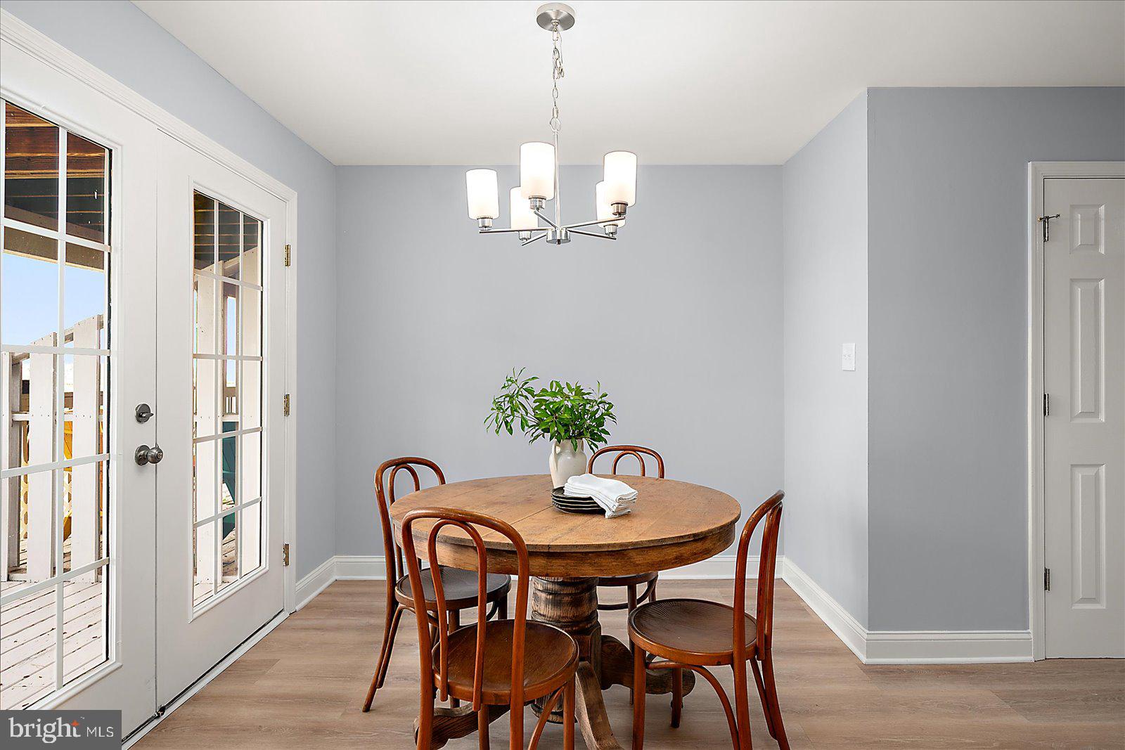 135 Jamestown Road, Unit 18A Ocean City, MD 21842 - Photo 23 of 63 a dining room with furniture a chandelier and wooden floor