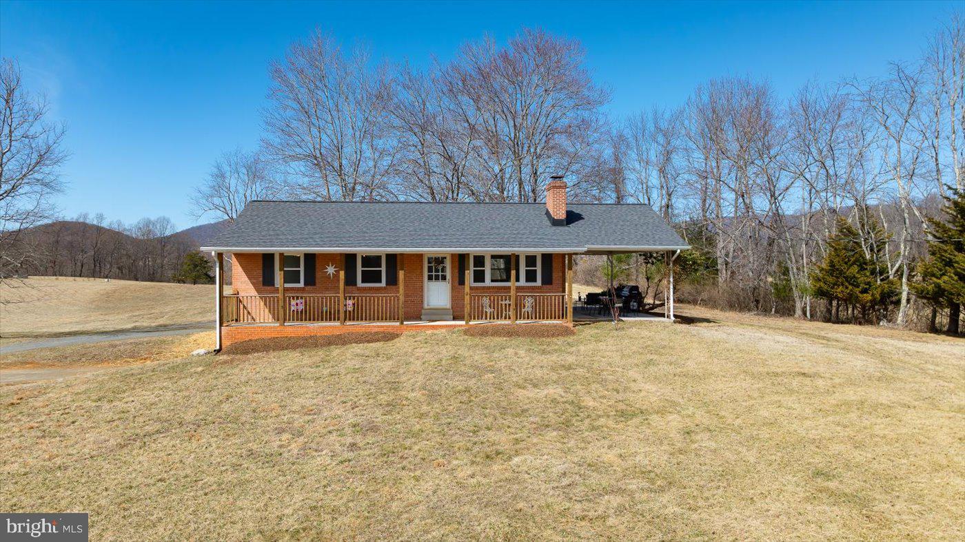 297 Tiger Valley Road Washington, VA 22747 - Photo 1 of 39 a front view of a house with yard and trees