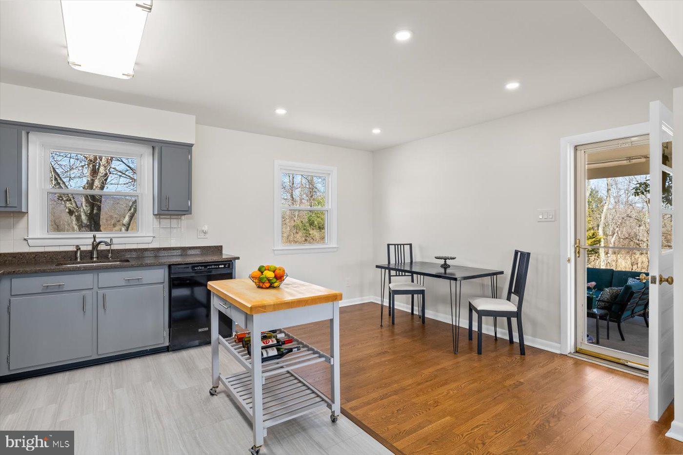 297 Tiger Valley Road Washington, VA 22747 - Photo 11 of 39 a kitchen with stainless steel appliances granite countertop a table and chairs in it