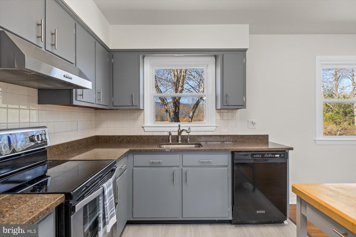 297 Tiger Valley Road Washington, VA 22747 - Photo 12 of 39 a kitchen with granite countertop a sink a stove and cabinets