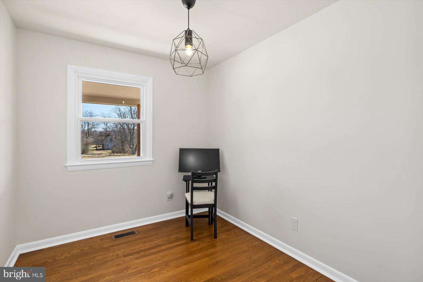 297 Tiger Valley Road Washington, VA 22747 - Photo 20 of 39 a view of a livingroom with wooden floor and workspace