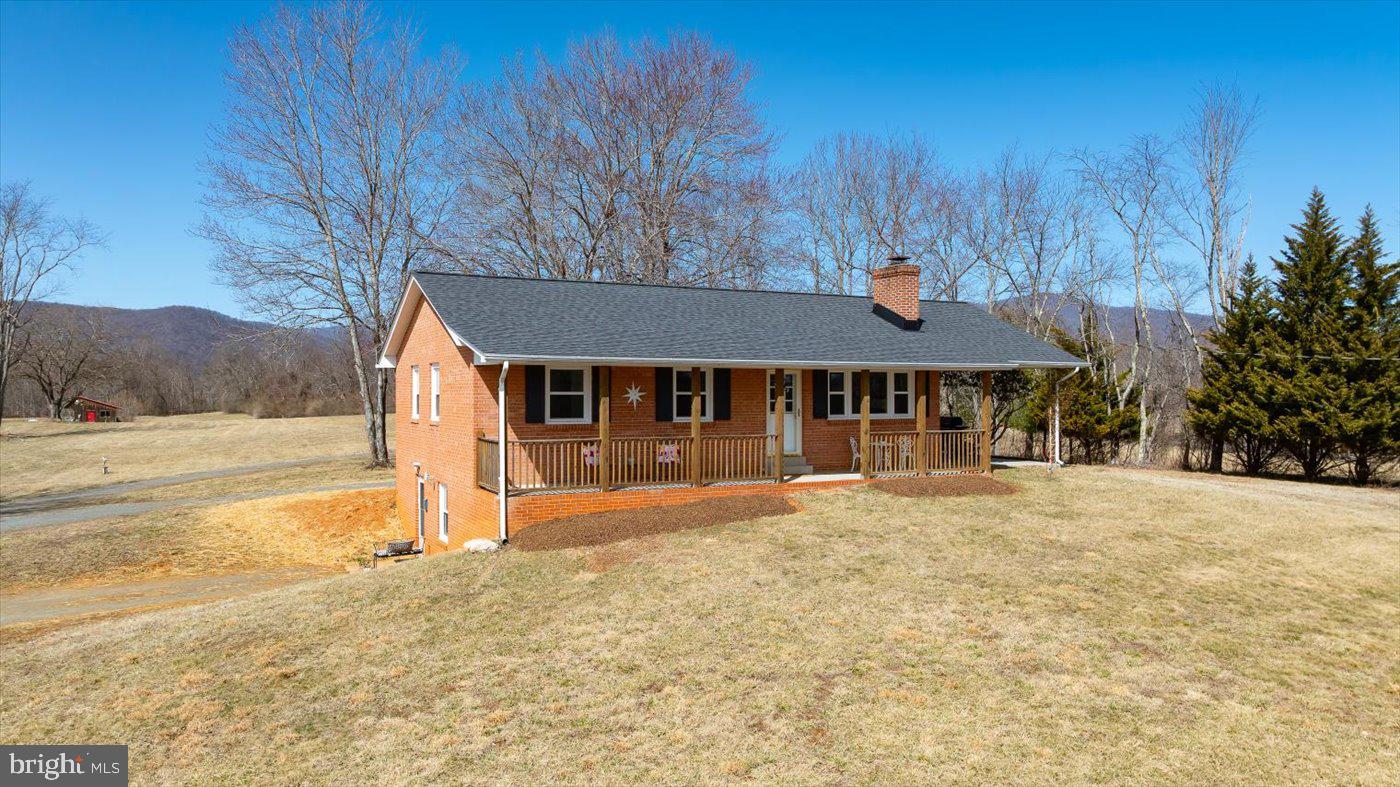 297 Tiger Valley Road Washington, VA 22747 - Photo 27 of 39 a front view of a house with a yard covered with snow in the background