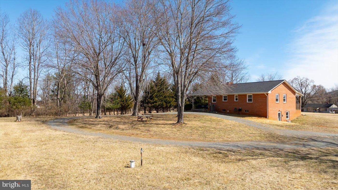 297 Tiger Valley Road Washington, VA 22747 - Photo 30 of 39 a house with a yard covered with snow in front of house