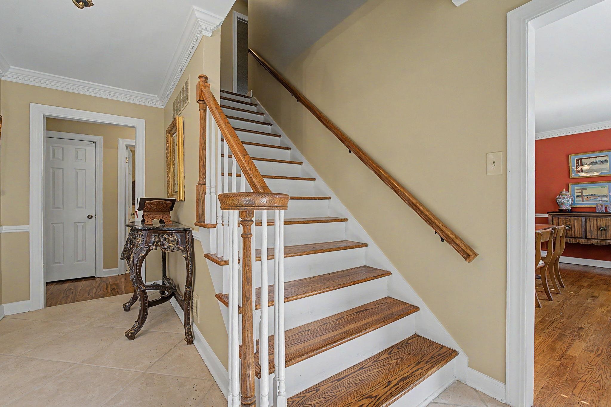1929 Miller Farms Road Germantown, TN 38138 - Photo 18 of 40 Staircase featuring wood-finish treads, white risers, and a matching wood-finish handrail with white balusters